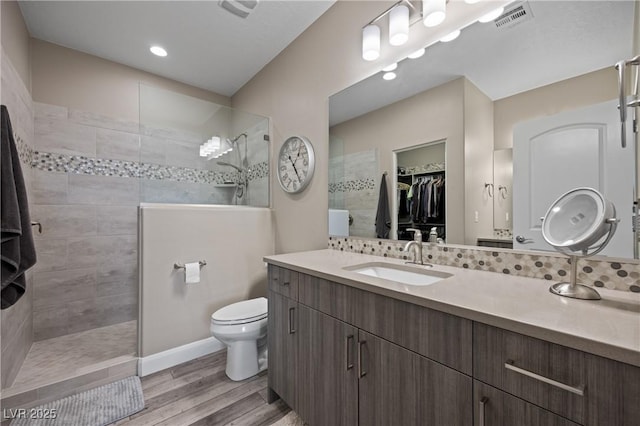 full bath featuring visible vents, a walk in shower, toilet, and wood finished floors