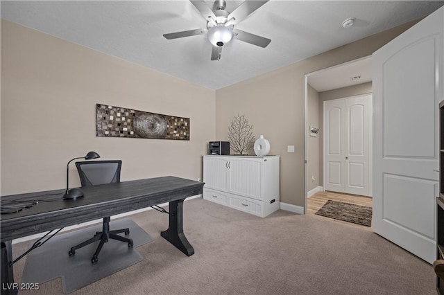 office with baseboards, carpet, and a ceiling fan