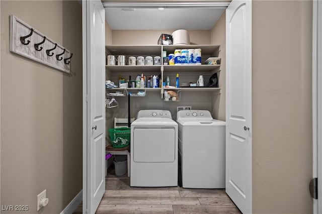 laundry room with laundry area, wood finished floors, and washing machine and dryer