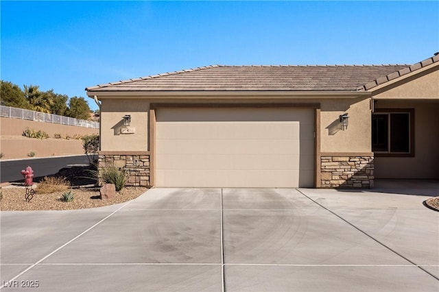 exterior space featuring stone siding, driveway, and stucco siding