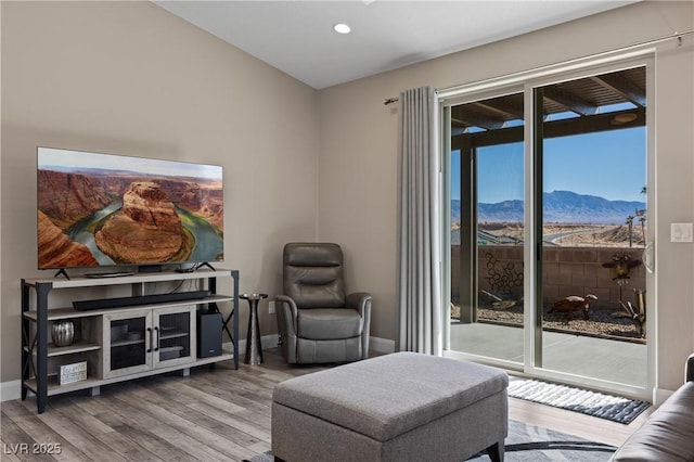 sitting room with recessed lighting, wood finished floors, a mountain view, and baseboards