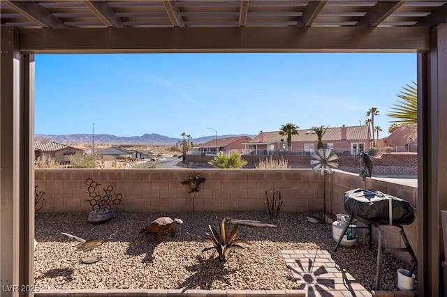 view of yard with a mountain view, a residential view, and a fenced backyard