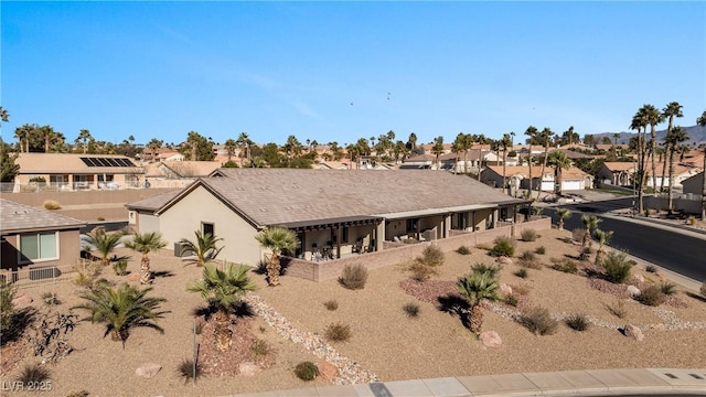 exterior space with stucco siding and a residential view