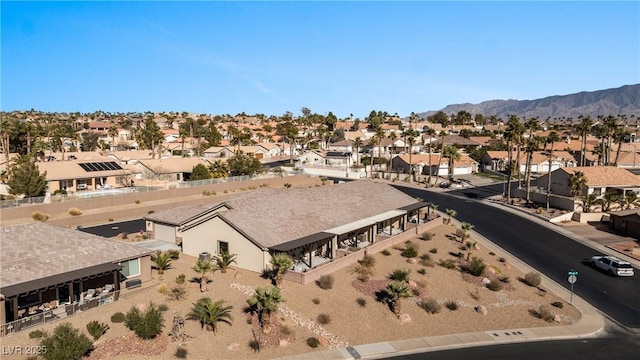 birds eye view of property with a mountain view and a residential view