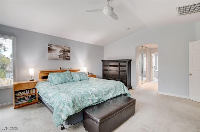 bedroom featuring carpet, visible vents, baseboards, arched walkways, and vaulted ceiling