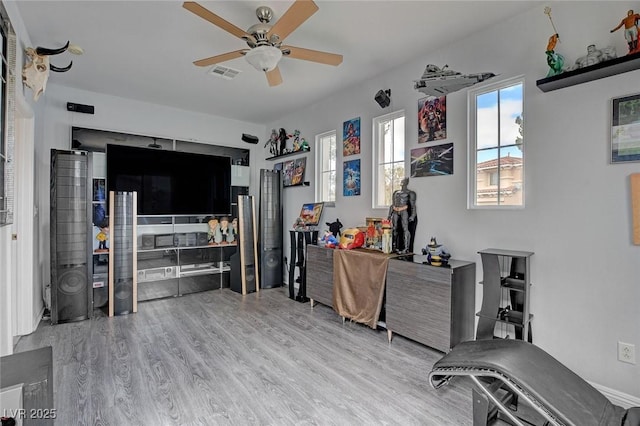 office space with visible vents, a ceiling fan, and wood finished floors