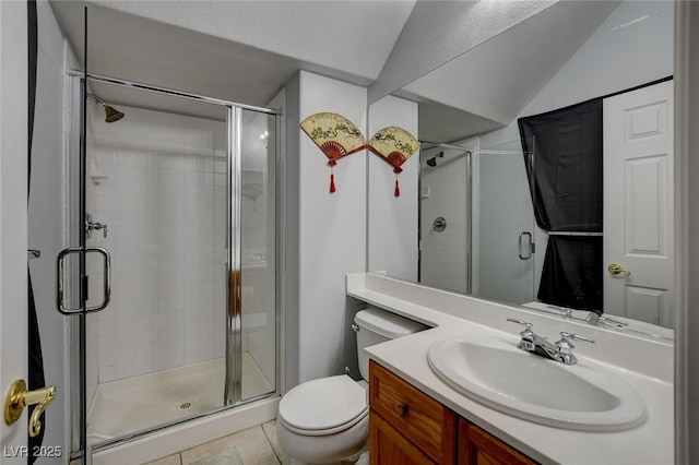 bathroom with vanity, vaulted ceiling, toilet, and a stall shower