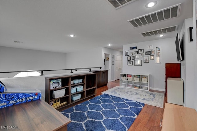 interior space with visible vents and wood finished floors