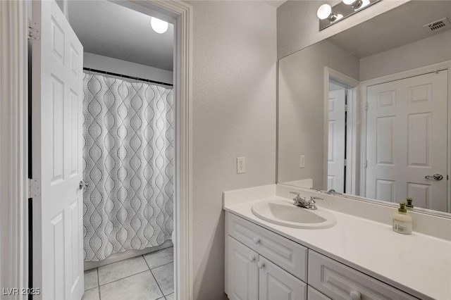 bathroom with tile patterned flooring, visible vents, curtained shower, and vanity