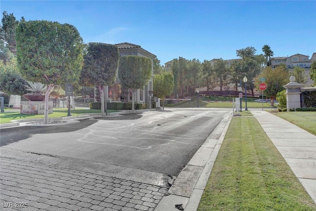 view of road with traffic signs, curbs, and sidewalks