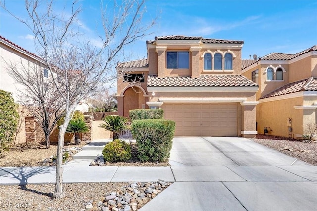 mediterranean / spanish-style house with a tile roof, concrete driveway, a garage, and stucco siding