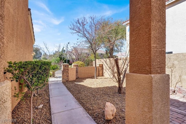 view of yard featuring fence and a gate