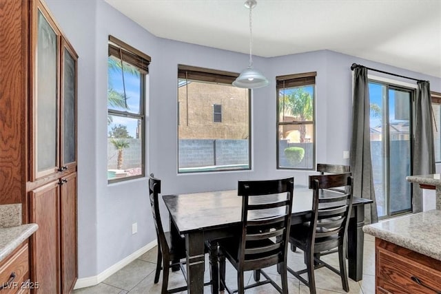 dining area with light tile patterned floors and baseboards