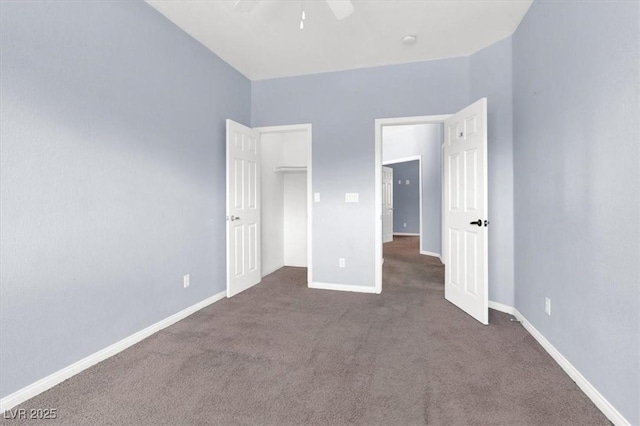 unfurnished bedroom with baseboards, carpet floors, and a ceiling fan