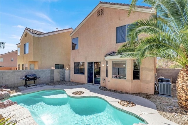 view of swimming pool featuring area for grilling, central AC unit, a fenced in pool, and a fenced backyard