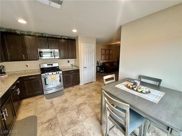 kitchen with recessed lighting, stainless steel appliances, dark brown cabinetry, and visible vents