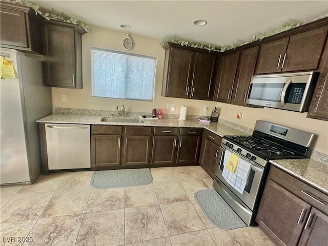 kitchen with a sink, dark brown cabinetry, appliances with stainless steel finishes, and recessed lighting