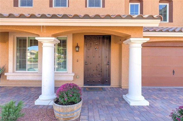 entrance to property featuring stucco siding and a tile roof