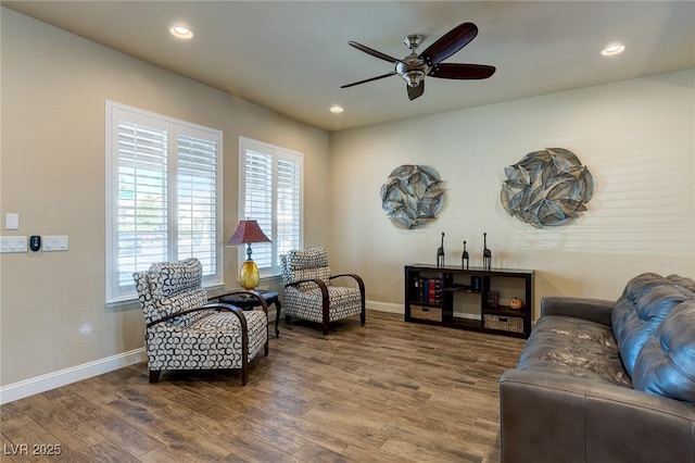 sitting room with ceiling fan, baseboards, wood finished floors, and recessed lighting