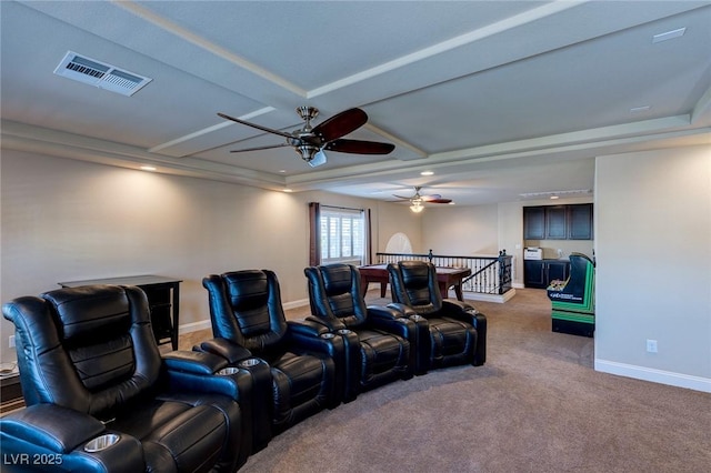 carpeted cinema room featuring visible vents, baseboards, and a ceiling fan