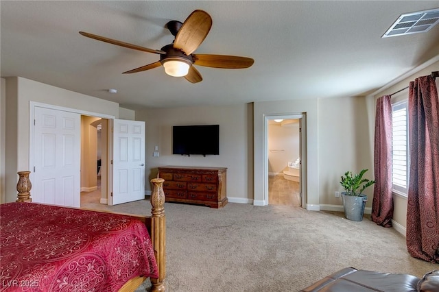 carpeted bedroom featuring ceiling fan, baseboards, visible vents, and connected bathroom