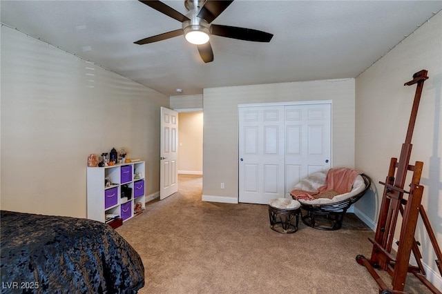 bedroom with a closet, baseboards, a ceiling fan, and carpet