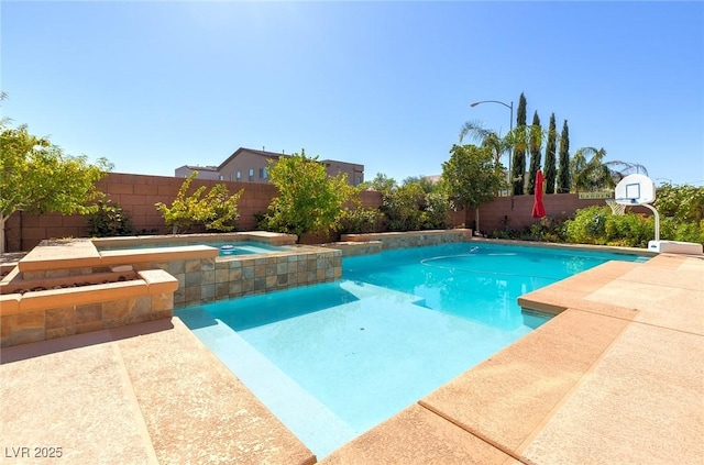 view of swimming pool with an in ground hot tub, a fenced backyard, and a fenced in pool