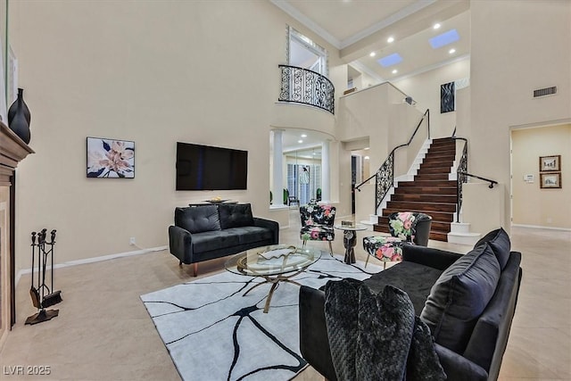 living room with stairway, baseboards, visible vents, a high ceiling, and ornamental molding