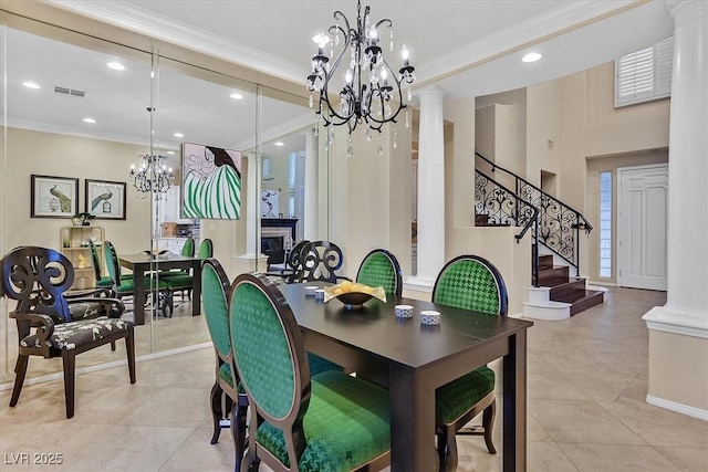 dining room featuring visible vents, crown molding, stairs, decorative columns, and a notable chandelier