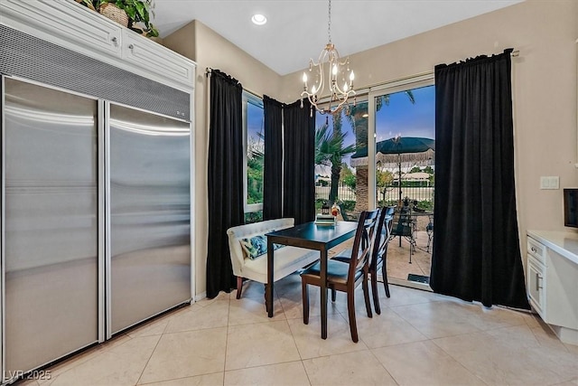 dining room with light tile patterned floors, recessed lighting, and a chandelier