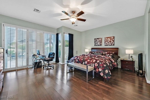 bedroom with multiple windows, wood finished floors, and access to exterior