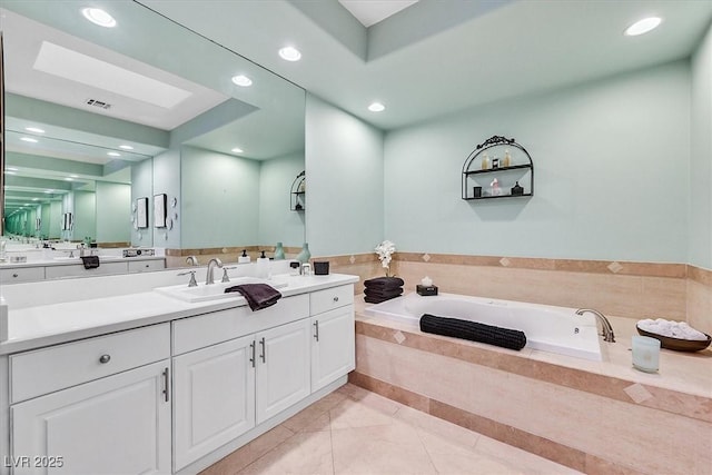 bathroom featuring visible vents, recessed lighting, vanity, and a garden tub