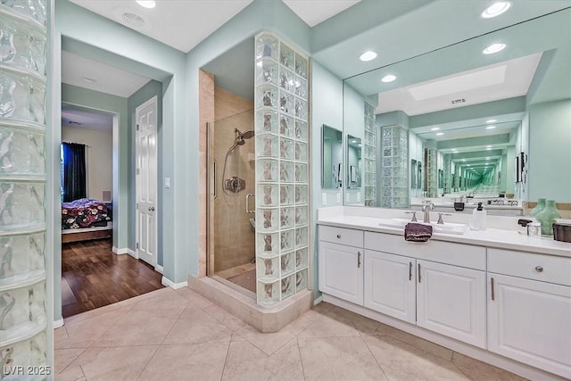 ensuite bathroom featuring vanity, recessed lighting, a stall shower, and connected bathroom