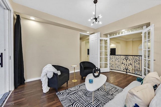 living area with recessed lighting, baseboards, an inviting chandelier, and wood finished floors