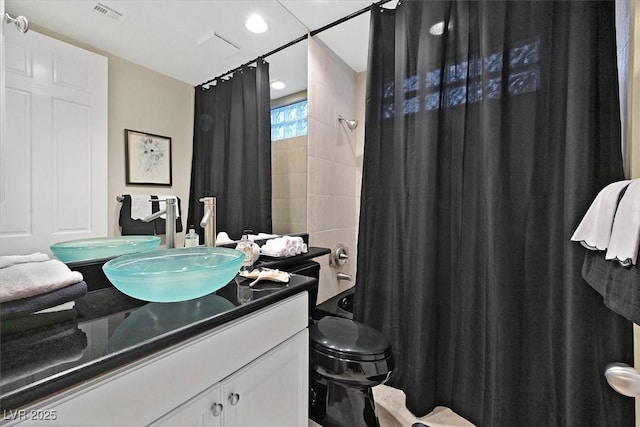 full bathroom featuring vanity, toilet, and visible vents