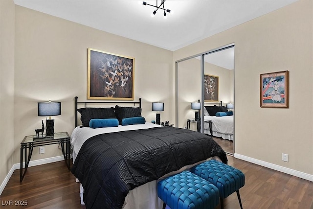 bedroom with a closet, baseboards, and wood finished floors