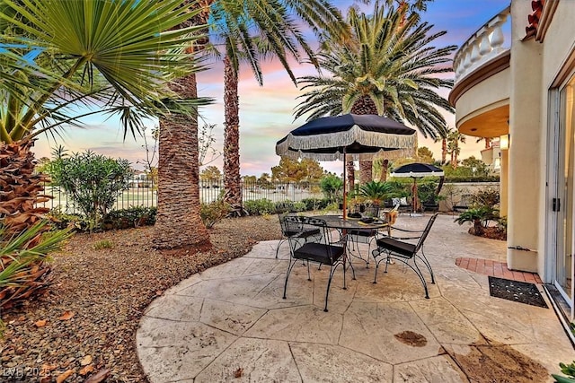 view of patio with outdoor dining space and fence