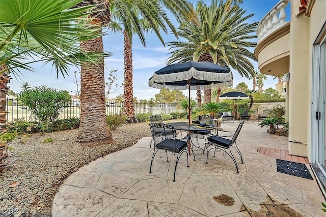 view of patio / terrace featuring outdoor dining space and fence