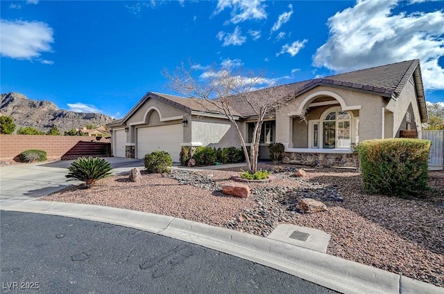 ranch-style house with a garage, fence, concrete driveway, and stucco siding