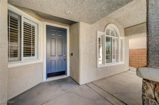 doorway to property with stucco siding