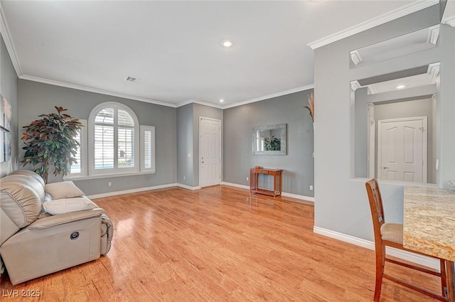 living area with light wood finished floors, recessed lighting, crown molding, and baseboards