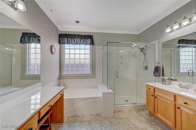 bathroom with vanity, a shower stall, a garden tub, and crown molding