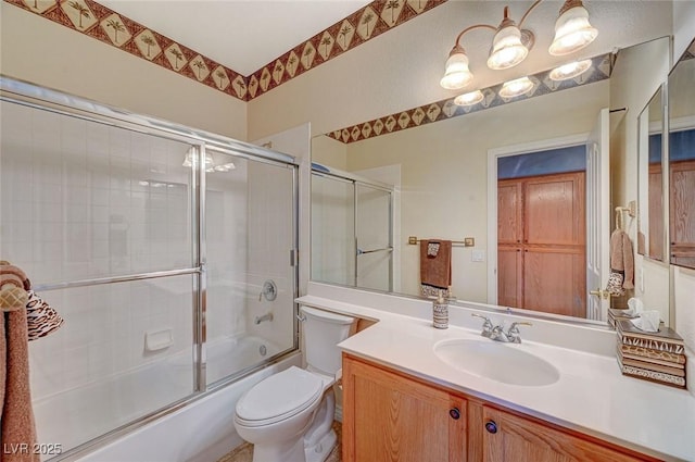 bathroom with enclosed tub / shower combo, toilet, and vanity