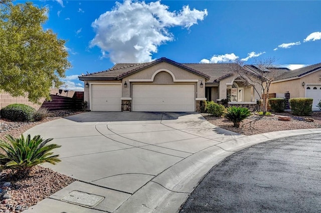 ranch-style house with stucco siding, driveway, stone siding, fence, and an attached garage