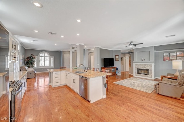 kitchen featuring a sink, stainless steel appliances, visible vents, and open floor plan