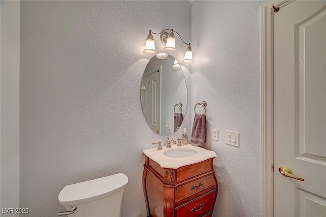 bathroom with toilet and vanity