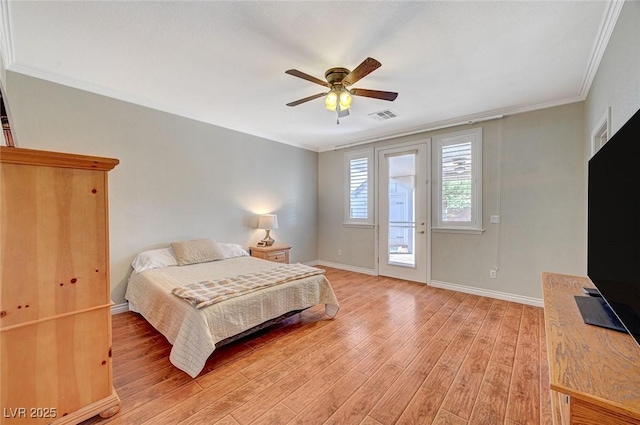 bedroom with crown molding, light wood-style flooring, baseboards, and visible vents