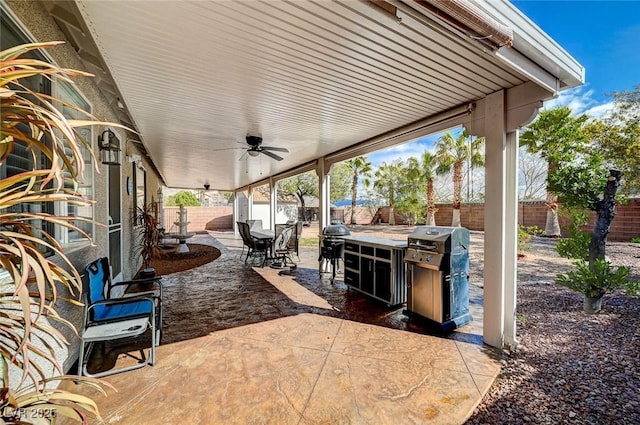 view of patio featuring a fenced backyard, a grill, and a ceiling fan