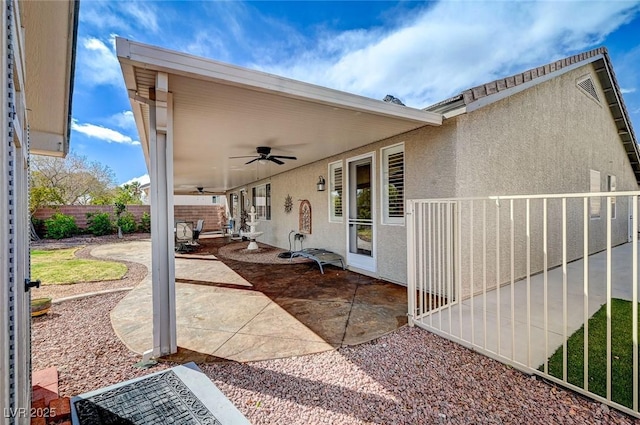 view of patio with a ceiling fan and fence