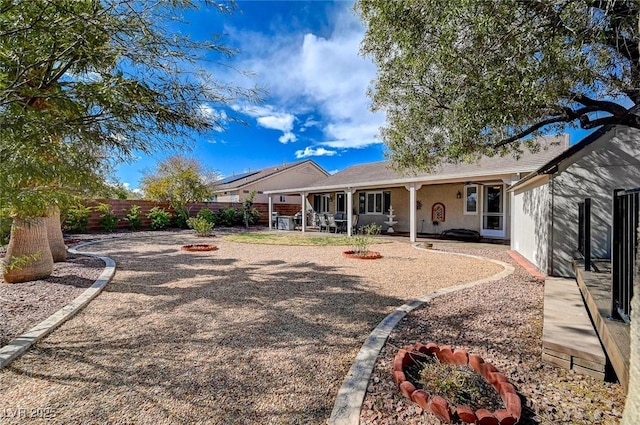 back of property with a patio area, an outdoor fire pit, and a fenced backyard